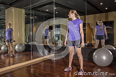 Body Conscious woman looking at herself in mirror Stock Photo