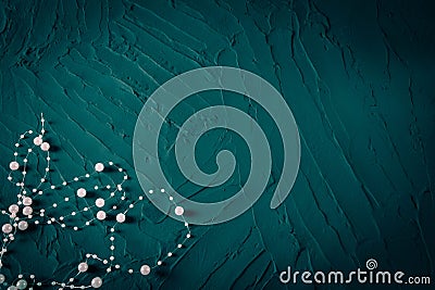 Body decoration in the form of beads on a turquoise rough background Stock Photo