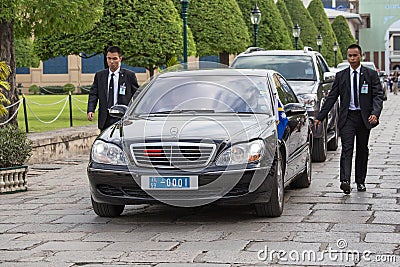 Body guards protect state automobile, which moves in the Grand Palace in Bangkok. Editorial Stock Photo