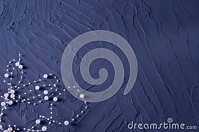 Body jewelry in the form of beads on a dark blue rough background Stock Photo