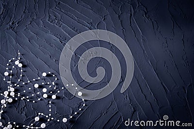 Body jewelry in the form of beads on a dark blue rough background Stock Photo