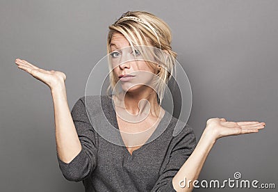 Body language concept for dubious 20s blond woman Stock Photo