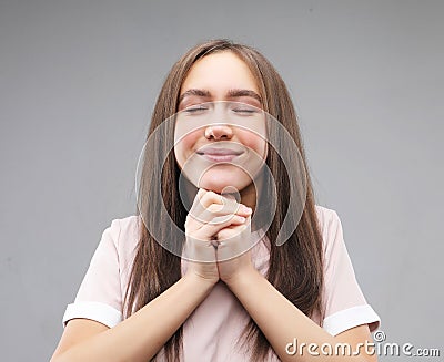 Superstitious teenager girl hoping her wishes will come true, having excited happy look Stock Photo