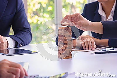 Body part Business engineers plays Jenga game and Orange hat. Stock Photo