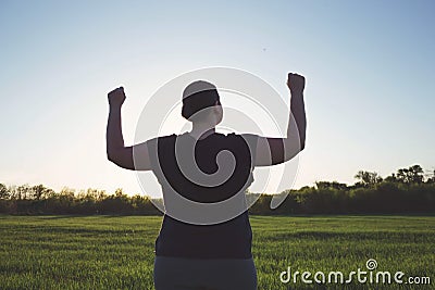Overweight woman celebrating rising hands to sky Stock Photo