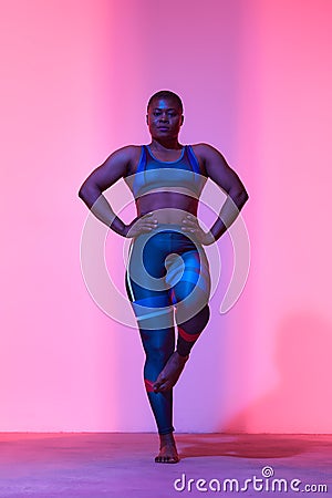 Body Positivity And Sport. Smiling Curvy Black Woman In Sportswear Free Copy Space For Advertisement, Standing Isolated Stock Photo