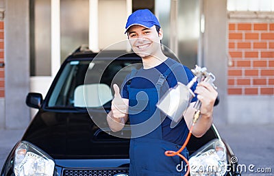 Body repairer holding a spray gun Stock Photo