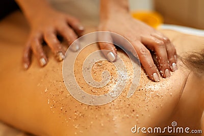 Body Scrub. Beautiful Blonde Gets a Salt Scrub Beauty Treatment Stock Photo