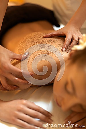 Body Scrub. Beautiful Blonde Gets a Salt Scrub Beauty Treatment Stock Photo