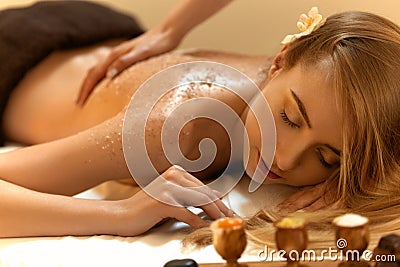 Body Scrub. Beautiful Blonde Gets a Salt Scrub Beauty Treatment Stock Photo