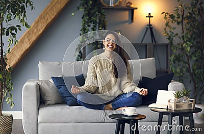 Cute smiling woman is learing yoga at home Stock Photo