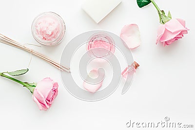 Body treatment with rose flowers and cosmetic set white desk background top view space for text Stock Photo