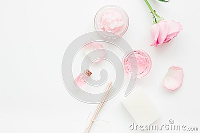 Body treatment with rose flowers and cosmetic set white desk background top view space for text Stock Photo