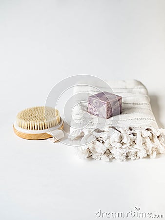 Body wooden brush, white towel and a piece of soap on a white background. Zero waste concept. Eco-friendly bath set. Copy space Stock Photo