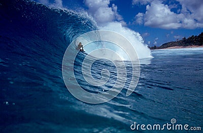 Bodyboarder Surfing a Big Blue Tube Wave Stock Photo