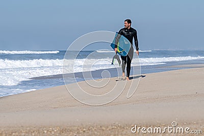 Bodyboarder walking Stock Photo