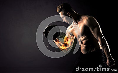 Bodybuilder athlete lifting weight with fire explode arm concept Stock Photo