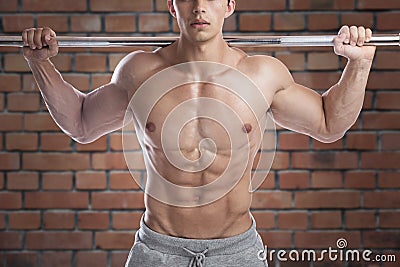 Bodybuilder bodybuilding muscles abs brick wall strong muscular Stock Photo