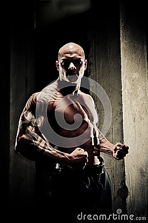 Bodybuilder Flexing Arms Stock Photo