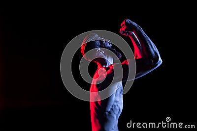 Bodybuilder gesturing and yelling isolated on black with dramatic lighting Stock Photo