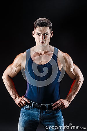 Bodybuilder posing. Beautiful sporty guy male power. Fitness muscled man in shirt. Stock Photo