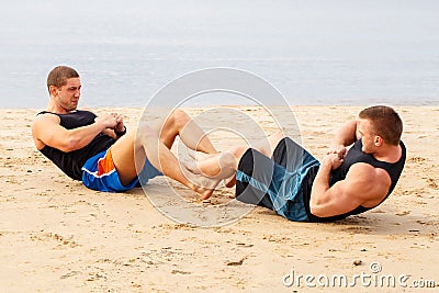 Bodybuilders on the beach Stock Photo
