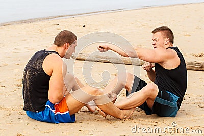 Bodybuilders on the beach Stock Photo
