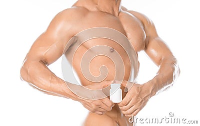 Bodybuilding and chemical additives: handsome strong bodybuilder holding a white jar of pills on white isolated background in stud Stock Photo