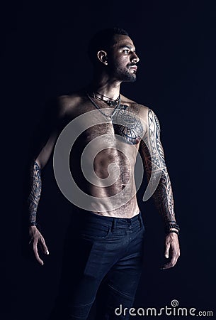 Bodycare with fitness and sport. Tattooed man show sexy muscular torso. Sportsman with six pack and ab. Bodybuilder with Stock Photo