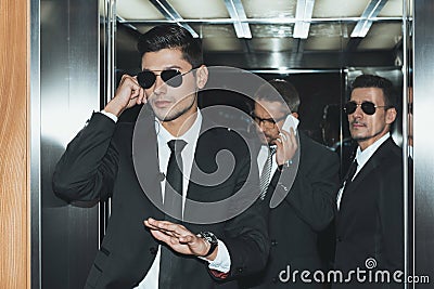 bodyguard listening security earpiece and businessman Stock Photo