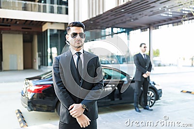 Officers Protecting Boss In Car Stock Photo