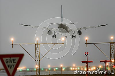 Boeing 767 landing with runway lights on. Stock Photo