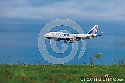 Boeing 747-400 Transaero Airlines on the background of storm clouds Editorial Stock Photo