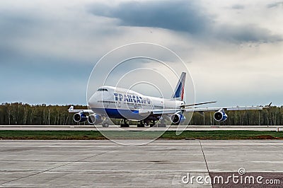 Boeing 747-400 Transaero Airlines is taxing the runway at the airport Editorial Stock Photo