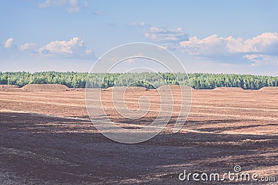 bog and the field on which the production is carried out in black peat mining - vintage film look Stock Photo