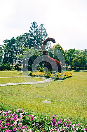 Bogor, Indonesia - A view of the flower themed park Taman Bunga Nusantara in a cloudy afternoon with a view to a bush shaped as a Editorial Stock Photo