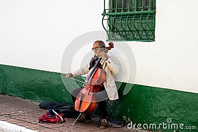 Bogota, Colombia - July 2nd 2023. Senior male musician performing on the streets of La Candelaria at the city center of Bogota Editorial Stock Photo