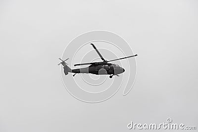 Police black hawk helicopter flying over crow during colombian independence military parade day Editorial Stock Photo