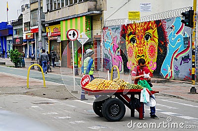 BOGOTA, COLOMBIA, JUNE 28, 2019: Fruit seller with trolley on the street. Editorial Stock Photo