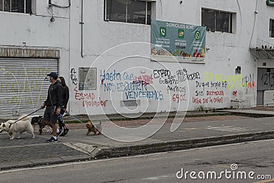 A young couple watching a lot of graffiti art against Government during colombian paro nacional marches Editorial Stock Photo