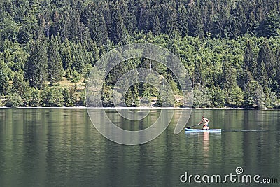 Bohinj, Slovenia - June 4, 2017: Tourist on a small boat in lake Bohinj, a famous destination not far from lake Bled. Editorial Stock Photo