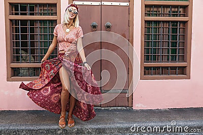 Boho girl walking on the city street Stock Photo