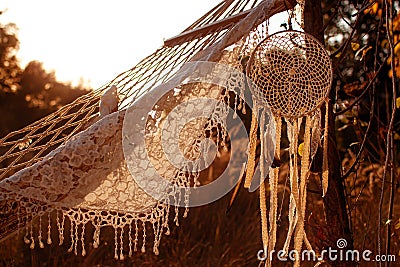 Boho style, hammock in spikelet background at sunset. Lightness and simplicity. Stock Photo