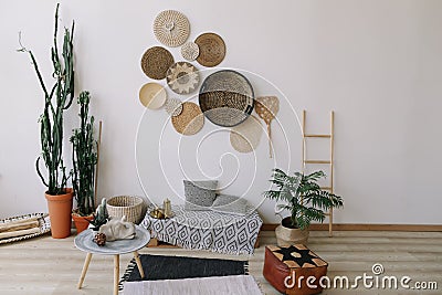 Boho style, minimal home interior design. Decorative straw plates on the wall. Exotic interior. Stock Photo