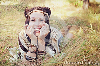 Boho style smiling woman portrait, girl have a fun lying outdoor in autumn sunny park Stock Photo