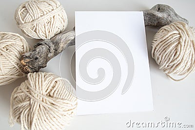 Boho vertical postcard mockup with white yarn on a white table background. Rustic bohemian image. Space for text. Good for macrame Stock Photo