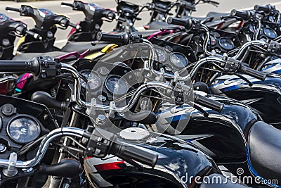 Bohol, Philippines - Rows of Kawasaki Bajaj 125 motorcycles for sale at a dealership. Motorbikes at an outdoor lot Editorial Stock Photo