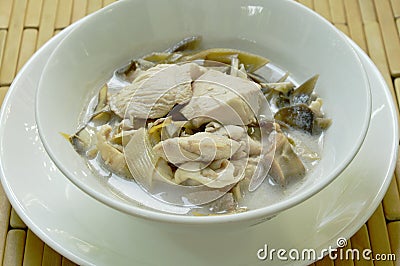 Boiled chicken with slice banana blossom in coconut milk soup on bowl Stock Photo