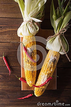 Boiled corn with salt, parmesan, herbs, chili peppers Stock Photo
