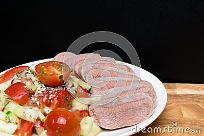 boiled cutting raw tongue with salad on white plate Stock Photo